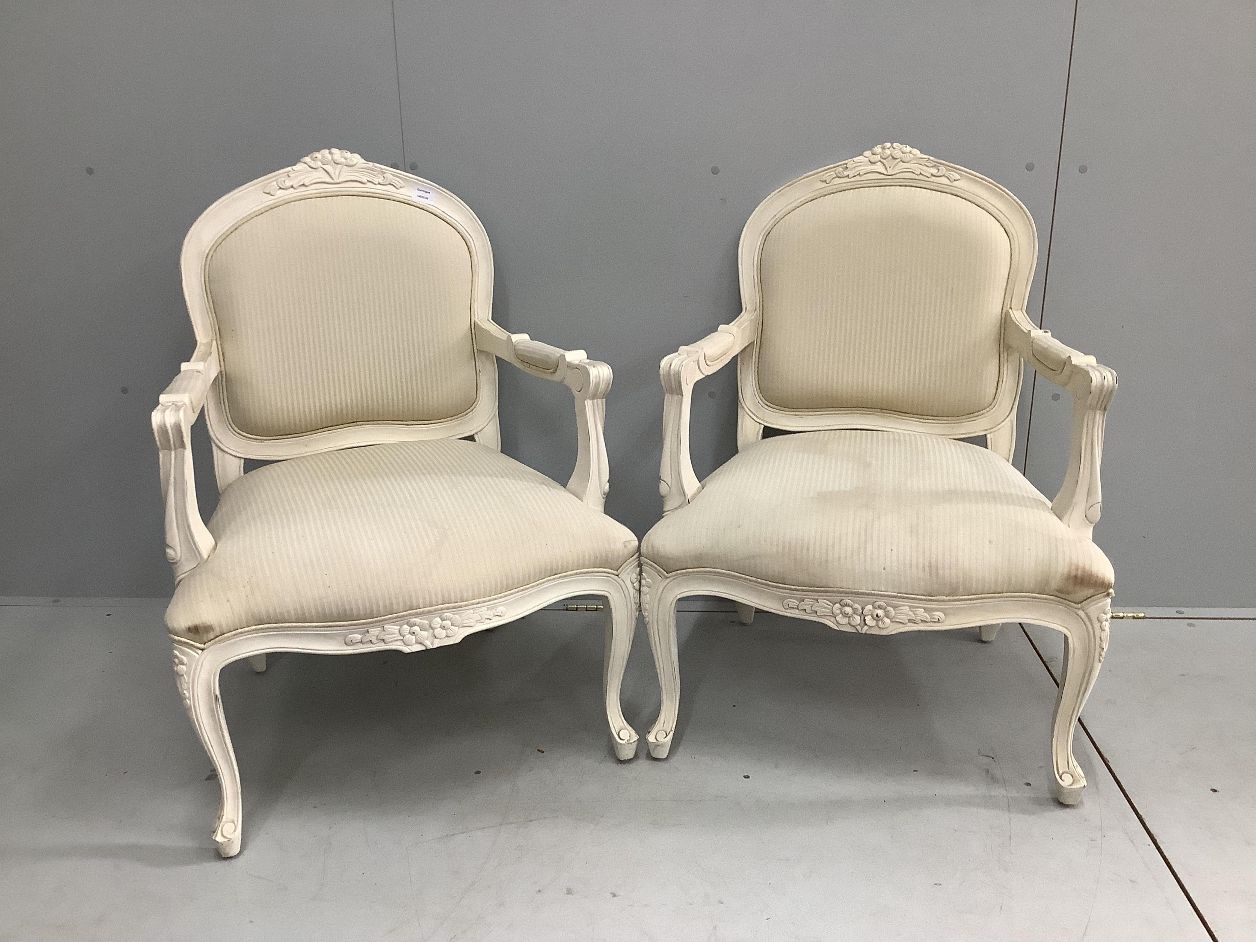 A pair of Louis XV style cream painted fauteuil, width 66cm, depth 60cm, height 94cm. Condition - fair